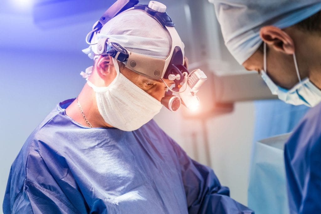 Two surgeons in operating room with surgery equipment 